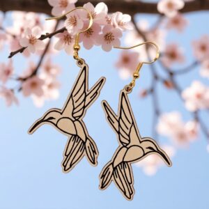 Pair of hummingbird dangle earrings with etched line art hanging on Gold fishhook wires hooks