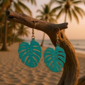 Green monstera leaf earrings featuring intricate cutouts and gold-tone hooks.