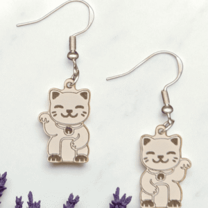 Pair of laser-cut wooden lucky cat earrings with engraved Maneki-neko details