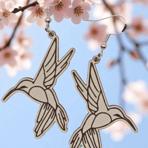 Pair of hummingbird dangle earrings with etched line art hanging on silver fishhook wires hooks