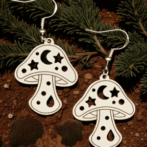 Pair of laser-cut wooden mushroom earrings with celestial crescent moon and star patterns